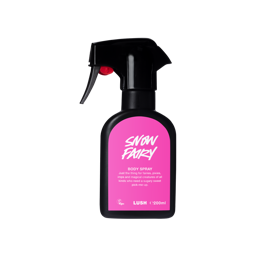 A recycled black plastic LUSH body spray bottle with a trigger nozzle stands upright with a vibrant pink label that reads "Snow Fairy Body Spray" and includes the product's whimsical description.