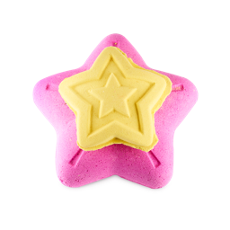 Snow Fairy Lights 3-in-1 bath bomb. The image shows a large, vibrant pink, five-pointed star bath bomb. A smaller, removable, yellow star with embossed lines sits on top