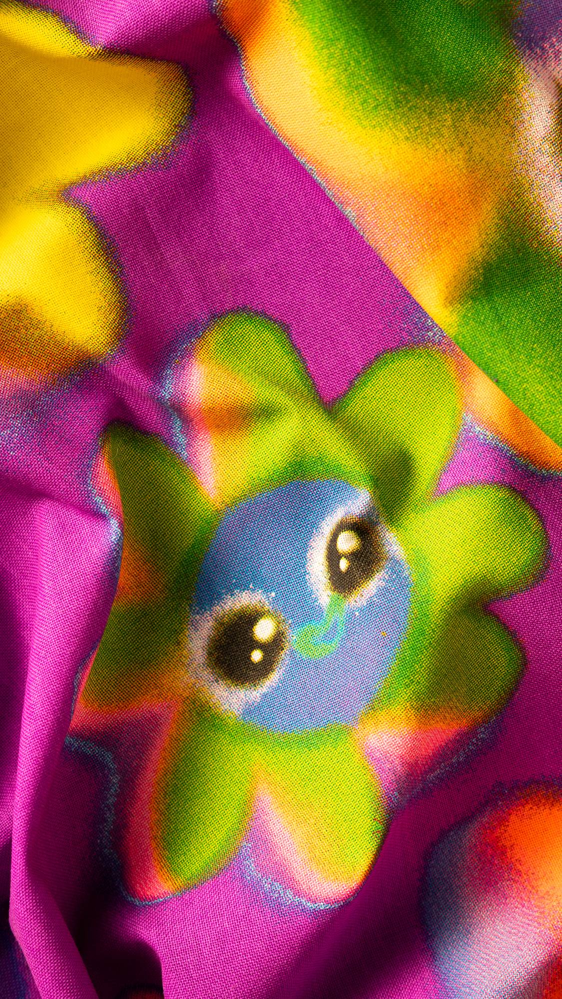 Image shows a super close-up of the Soopa Frens knot wrap with a deep purple background and vivid yellow and green flowers.