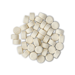 A pile of small, circular, white Sparkle toothpaste tabs shot from above. 