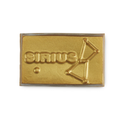 Spiritual Sun. A thick, rectangular soap slice covered in golden lustre with embossed text 'SIRIUS' on the left. The right side features a geometric, constellation-like pattern.