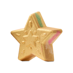 Star of Wonder. A five-pointed star-shaped bath bomb with a golden, glittery lustre. It features embossed firework-like patterns and colourful pink and green stripes on its side.