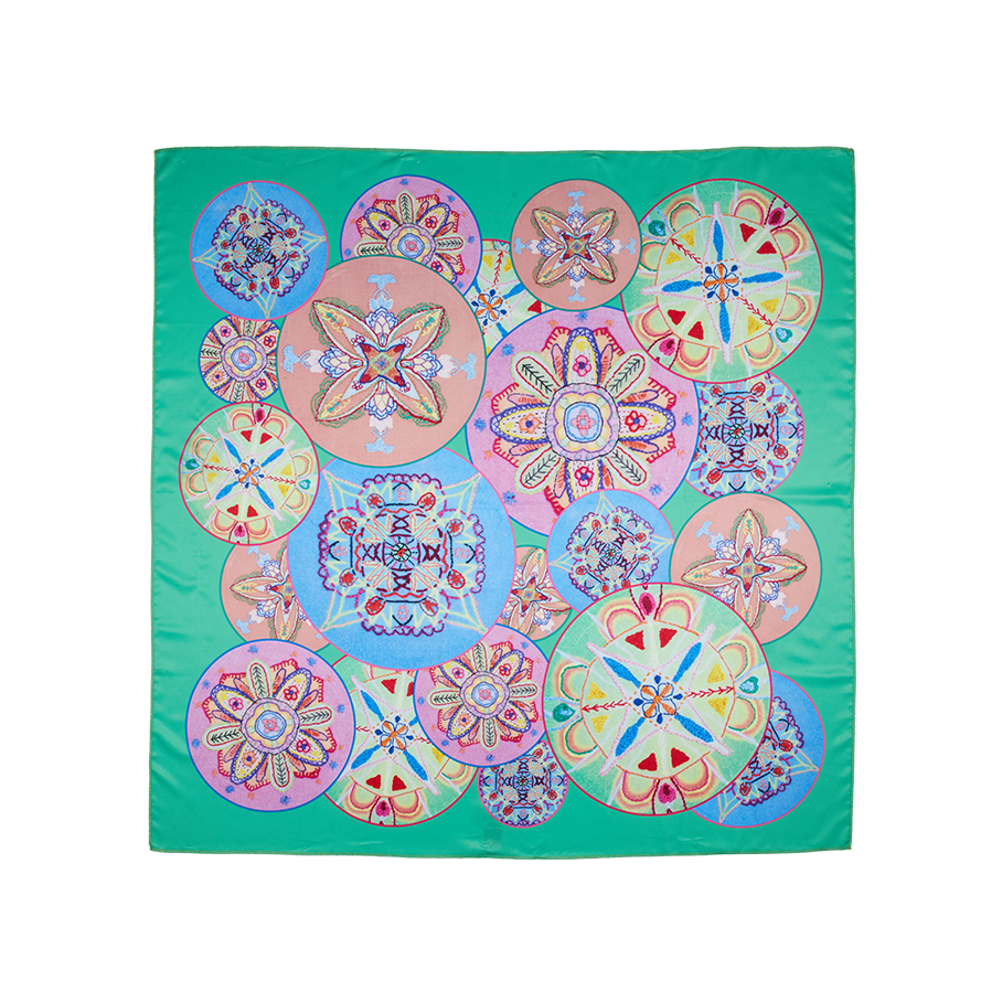 Star of Youth. A square, green knot wrap with circular shapes featuring symmetrical patterns. 