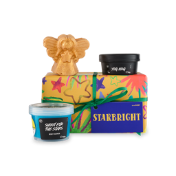 Starbright. A rectangular-shaped gift box wrapped in yellow paper with illustrated, colourful stars, tied with a green ribbon and gift tag. Three Christmas-themed products sit around the box. 