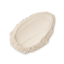 A studio shot of a textured swatch of LUSH Sticky Dates dusting powder, a fine, light beige powder against a light gray background.