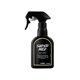 A recycled black plastic LUSH body spray bottle with a trigger nozzle stands upright with a creamy-yellow rimmed label with white text that reads "Super Milk Body Spray".