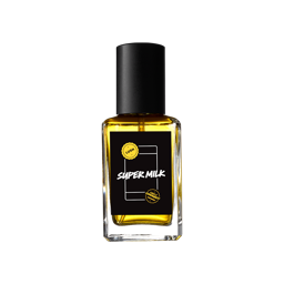 Super Milk. A square glass perfume bottle, topped with a black cap and filled with yellow-amber, transparent liquid. A black label reads 'Super Milk' with a LUSH X Community stamp design.