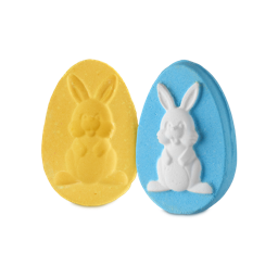 Surprise Bunny. A two-part bath bomb in the shape of two egg halves. One half is fully yellow with an embossed rabbit shape in the centre. The other half is blue with a protruding white bunny shape matching the yellow half.