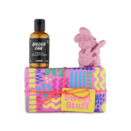 Sweet Stuff. A rectangular gift box wrapped in colourful paper with bold printed patterns of zigzags, lines and dots, tied with an orange string and yellow gift tag. Two Easter-themed products sit on top of the box. 