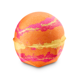 The Alchemist bath bomb. A spherical bath bomb with a geometric base, marbled with vibrant orange, pink, and golden bands. It is coated in shimmering lustre
