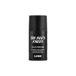 The Bee's Knees. A short, cylindrical black push-up tube of The Bee's Knees solid perfume with a black label on the front covering the cap, with the product name and scent printed on it. 