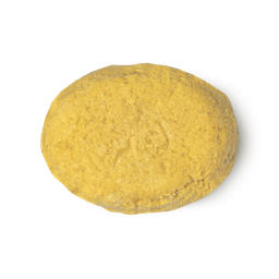 The Golden Cap. A golden yellow, oval shaped solid conditioner bar.