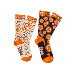 The Joy of Socks. Two groovy pairs of socks. They both have an orange toe, heel and trim with different warm, brown and orange patterns and "Happy Hippy" written around the top. 