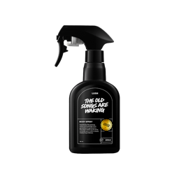 The Old Songs Are Waking. A black, opaque-plastic body spray bottle. The black label on the front reads "The Old Songs Are Waking" in large white letters. There is also a "Limited Edition" logo and some product information on the label. 