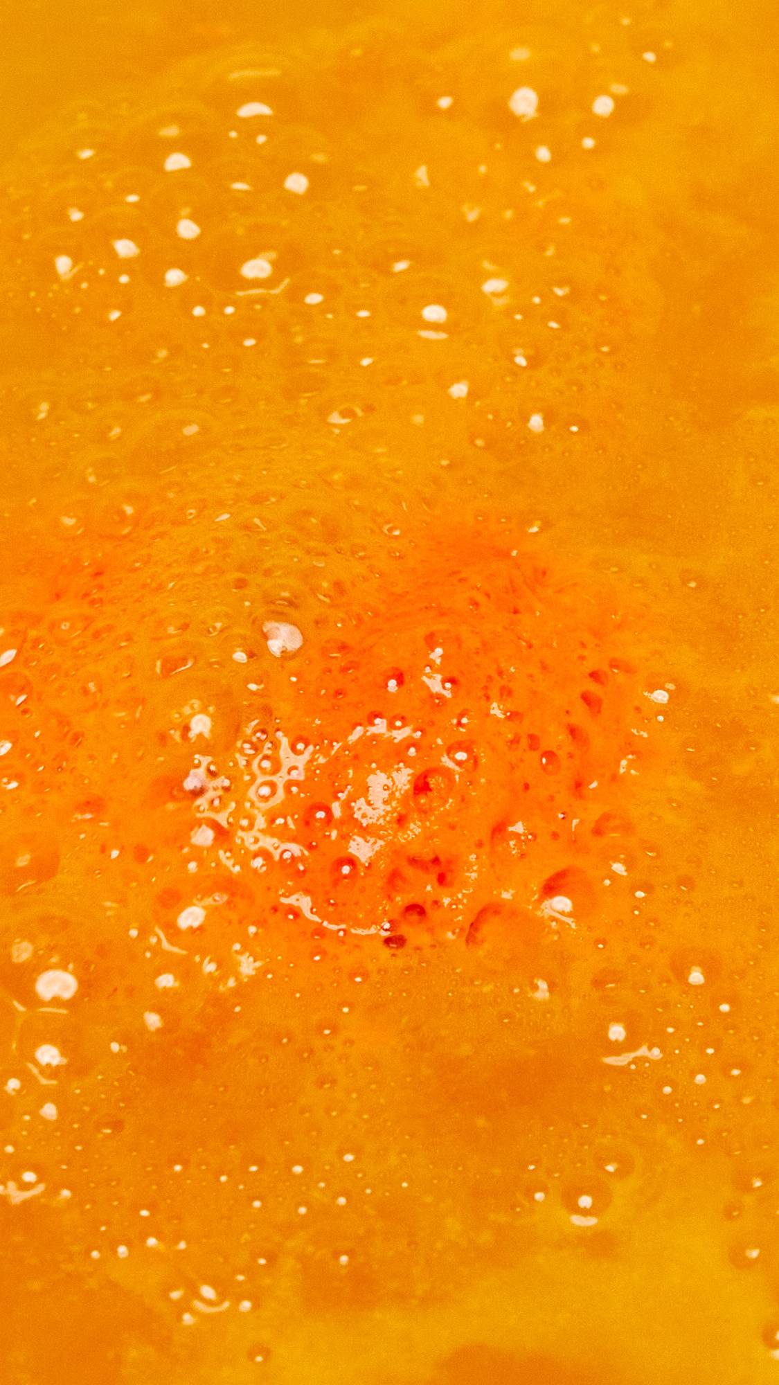 The One With The Orange Slices is slowly dissolving in the bath creating a thick, bubbly blanket of bright orange foam.