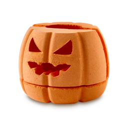 Pumpkin Tea Light. A dual-purpose bath bomb and tea light holder. An orange bath bomb in the shape of a jack-o'-lantern pumpkin. It has a carved, menacing face with triangular eyes and a jagged mouth.There are three parts to this product.