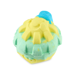 The Sun Has Got His Hat On. A playful, abstract-shaped bath bomb styled like a bright yellow, smiling sunshine wearing a blue cap on a green and yellow base. 