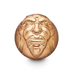 The Wizard. A spherical bath bomb. The front is embossed with a detailed face of a perfectly symmetrical male face complete with large eyebrows and facial wrinkles. The entire product is coated in a shining, golden lustre.