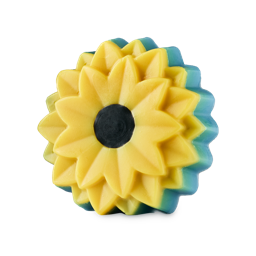There Will Be Sun. A decorative, sunflower-shaped soap with yellow, layered, concentric petals and a dark brown centre. The back of the flower has a contrasting teal-blue bottom layer.