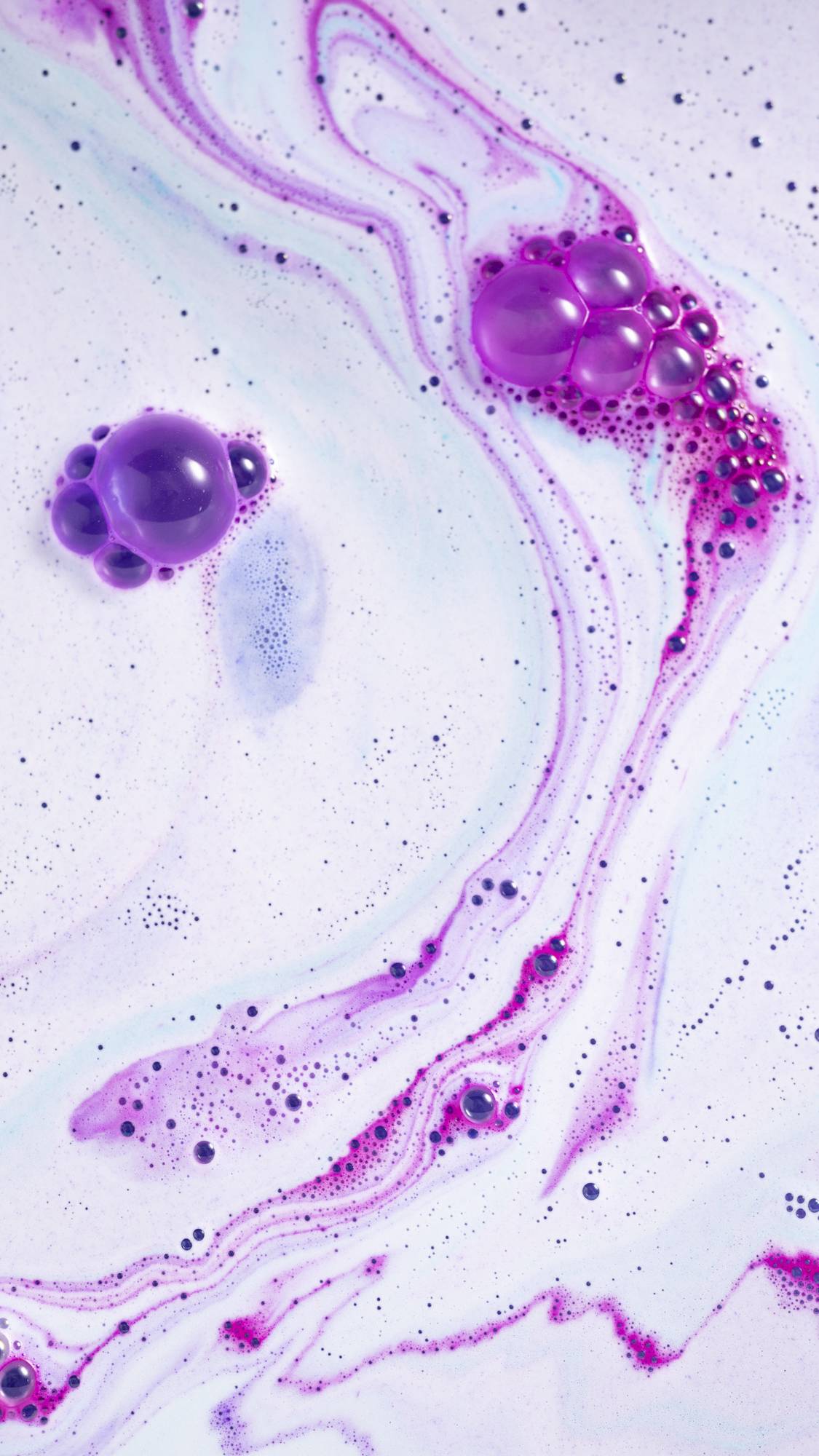 The bath bomb has fully dissolved leaving behind a galaxy of blue, pink and purple swirls. 