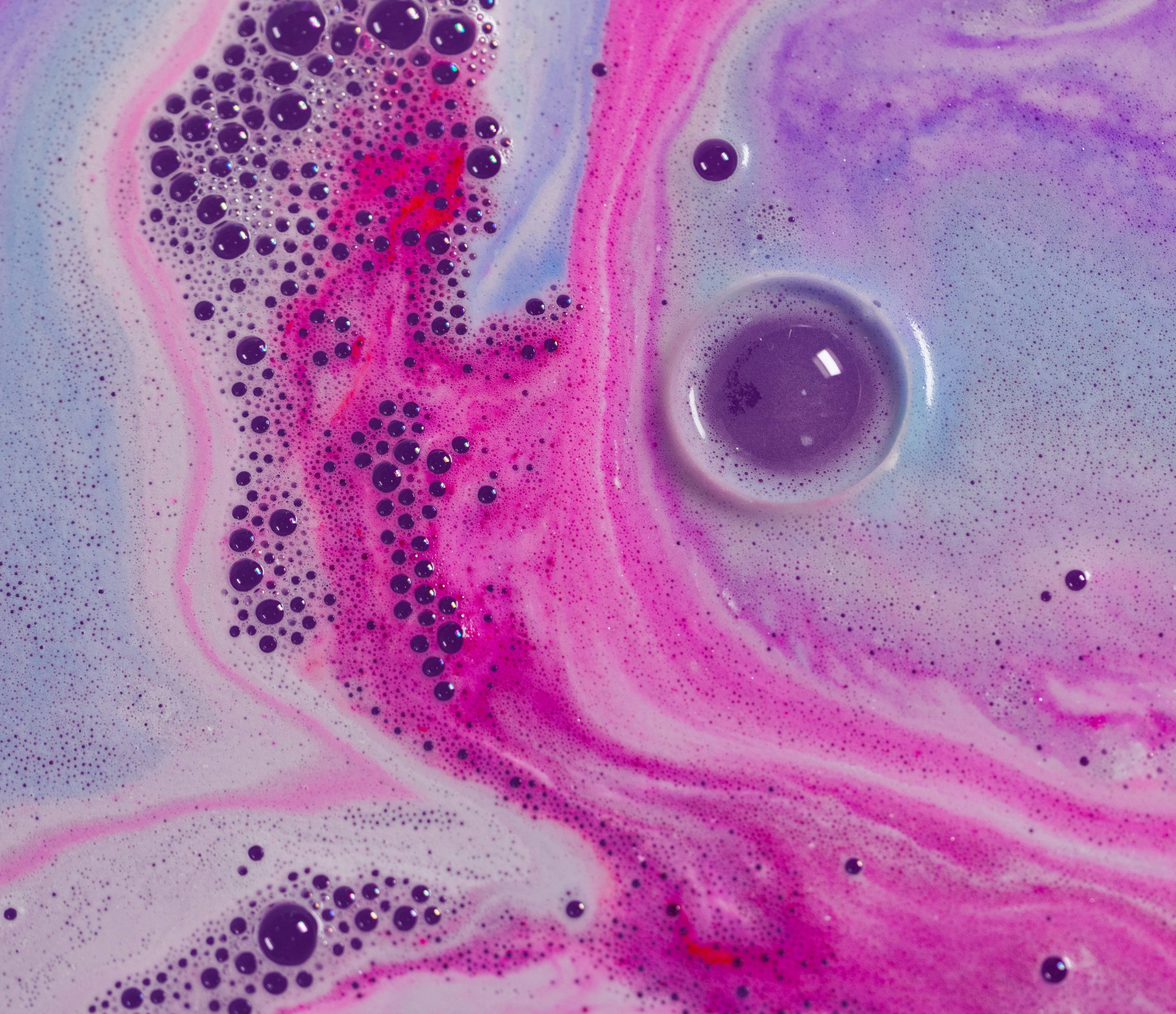 A close-up of colourful swirls of magical pink, blue and purple.
