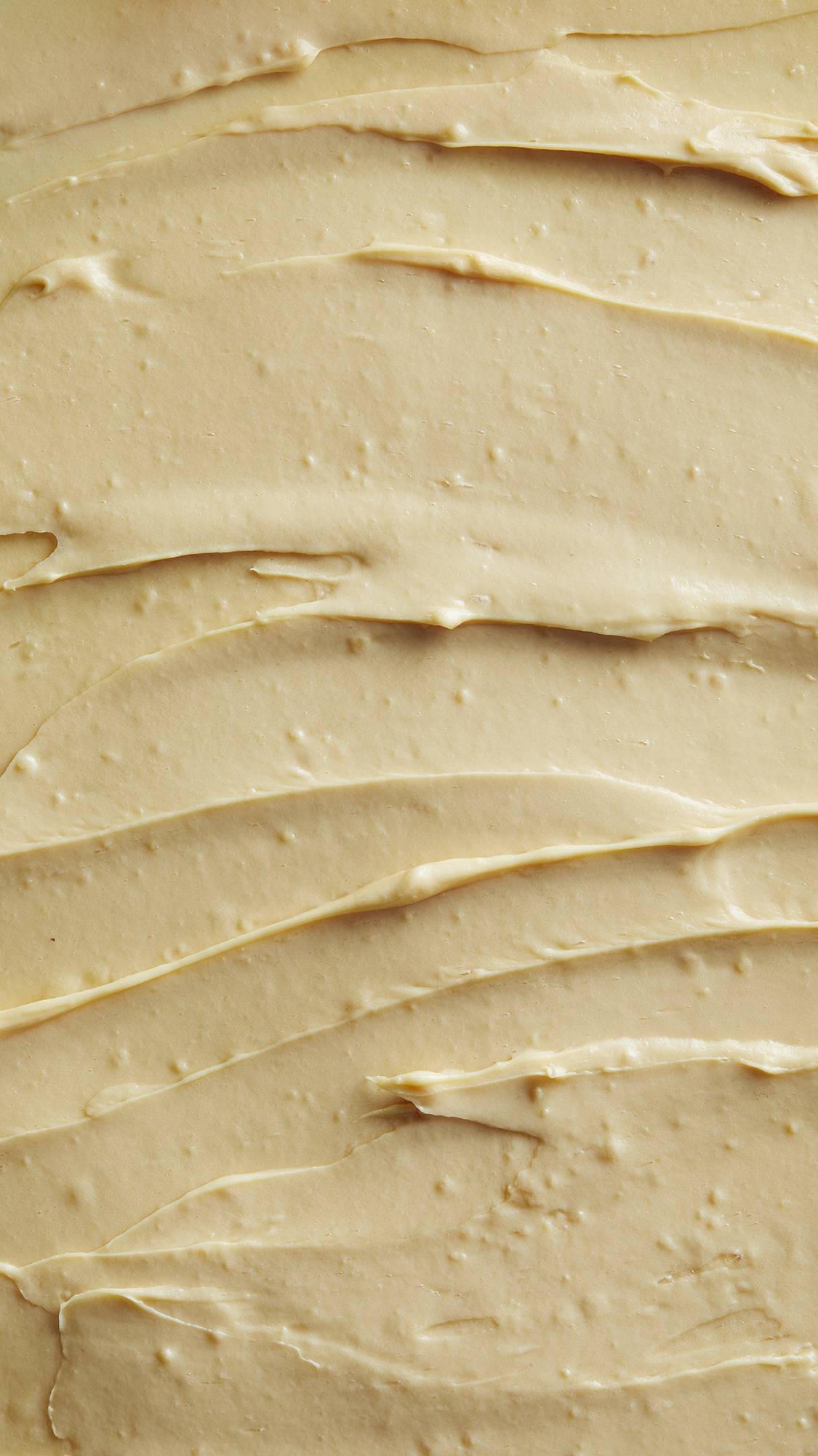 Image is a very defined close-up of the thick, pastel-yellow Tofu shampoo spread almost like a batter.