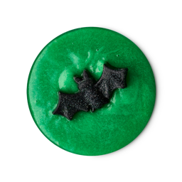 Toil and Trouble. A perfectly circular swatch of thick, glossy bright green shower slime. There is a small, solid, black bat-shaped soap on top. 
