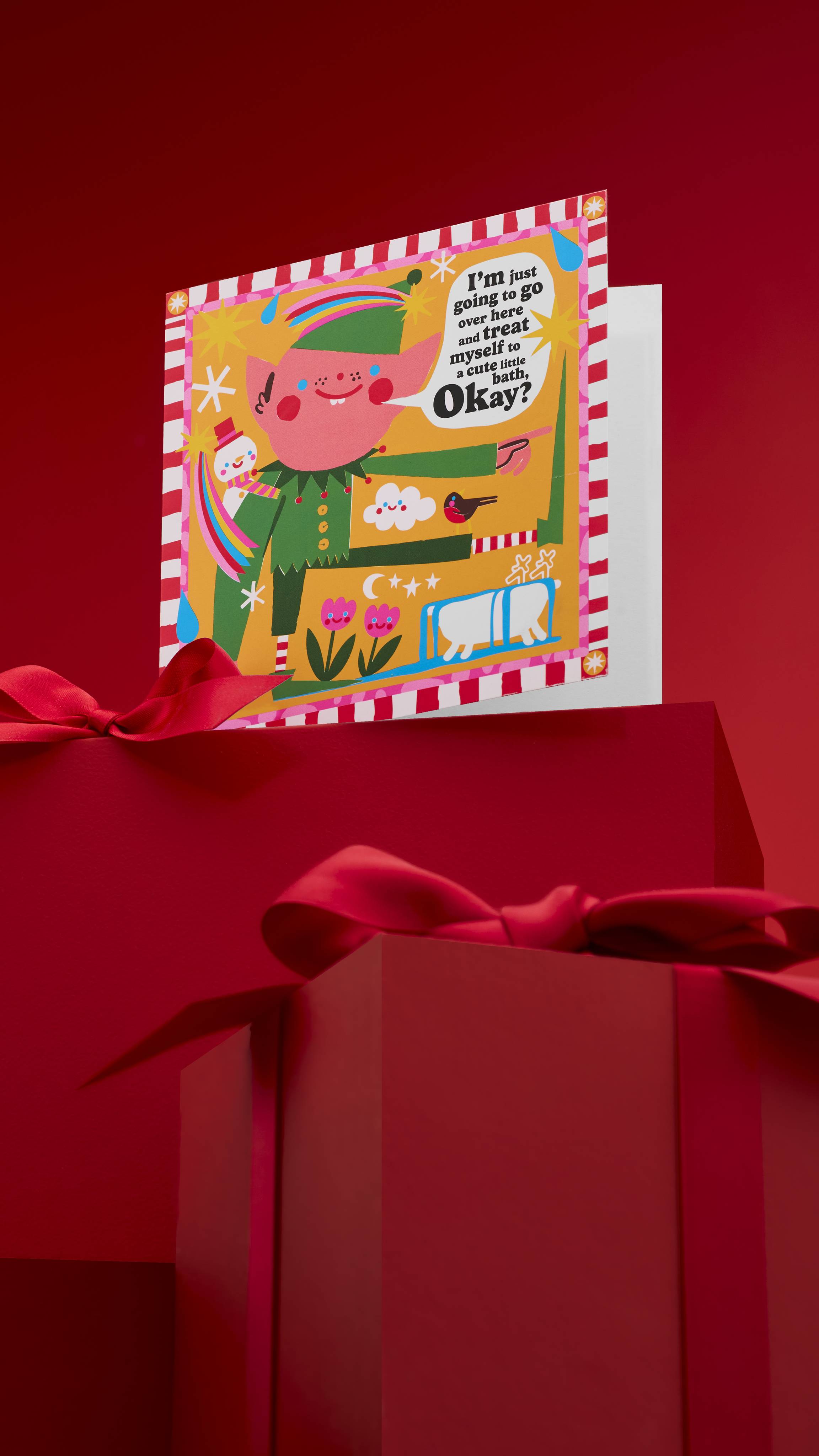 A festive "Treat Your Elf" greeting card with a whimsical elf standing next to a bathtub and saying, "I'm just going to go over here and treat myself to a calming bath. Okay?" The card is displayed on a red background with wrapped gifts.