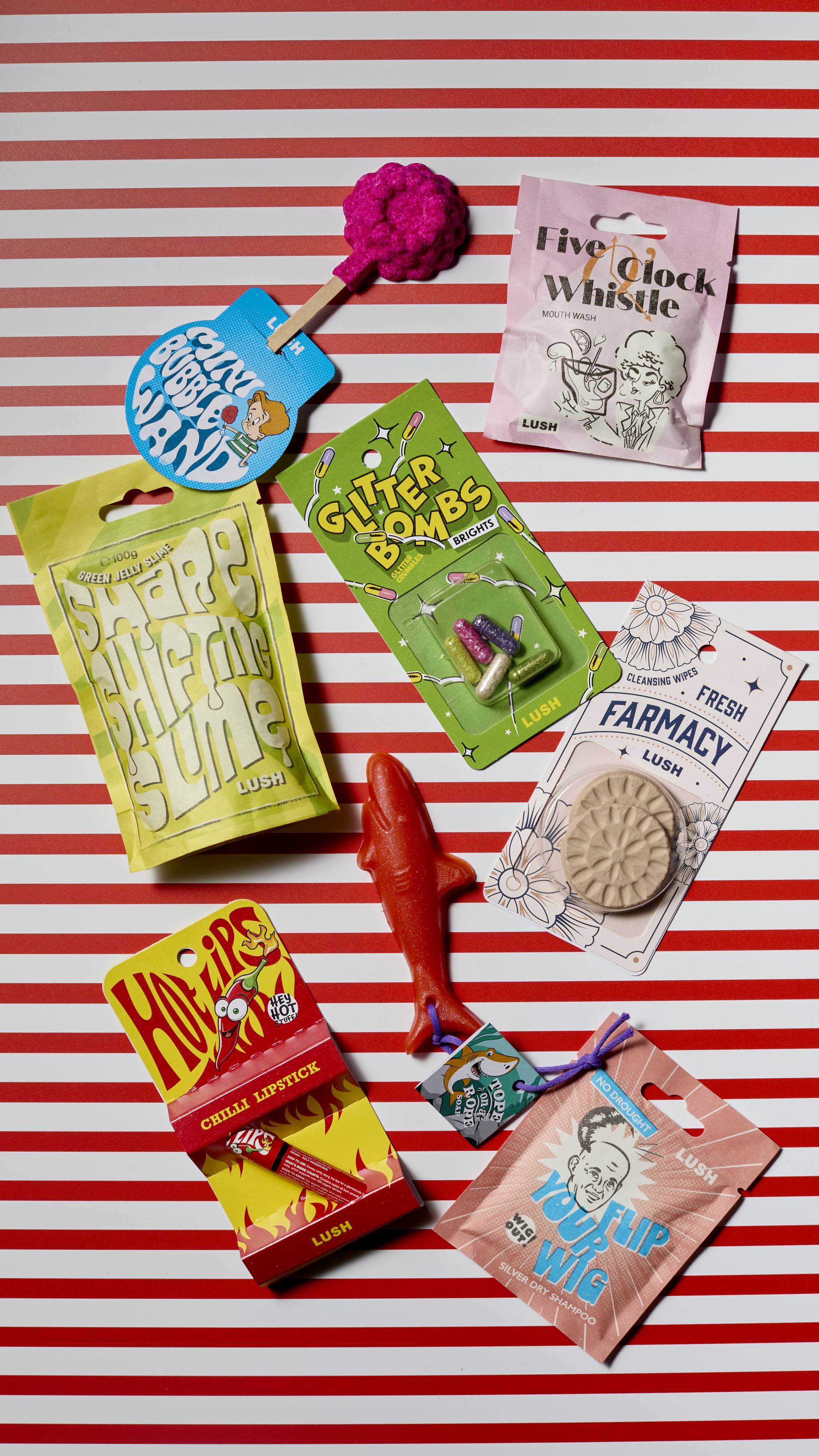 The image shows a red and white horizontally lined background. Eight colourful, nostalgically styled Tricks products are laid across the screen. 