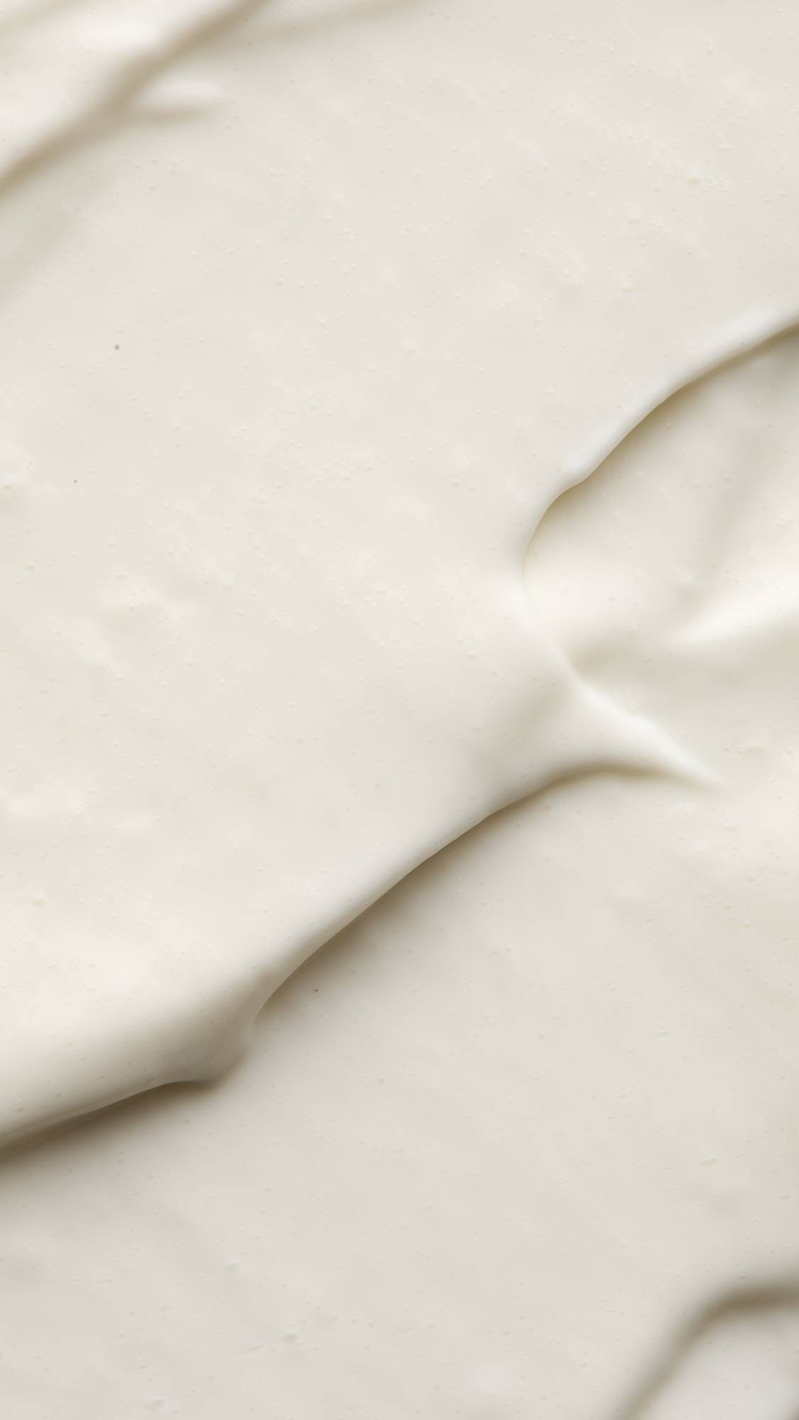 A super close-up image of the Vanishing Cream self-preserving moisturiser showing the light, silky, soft texture of the product. 
