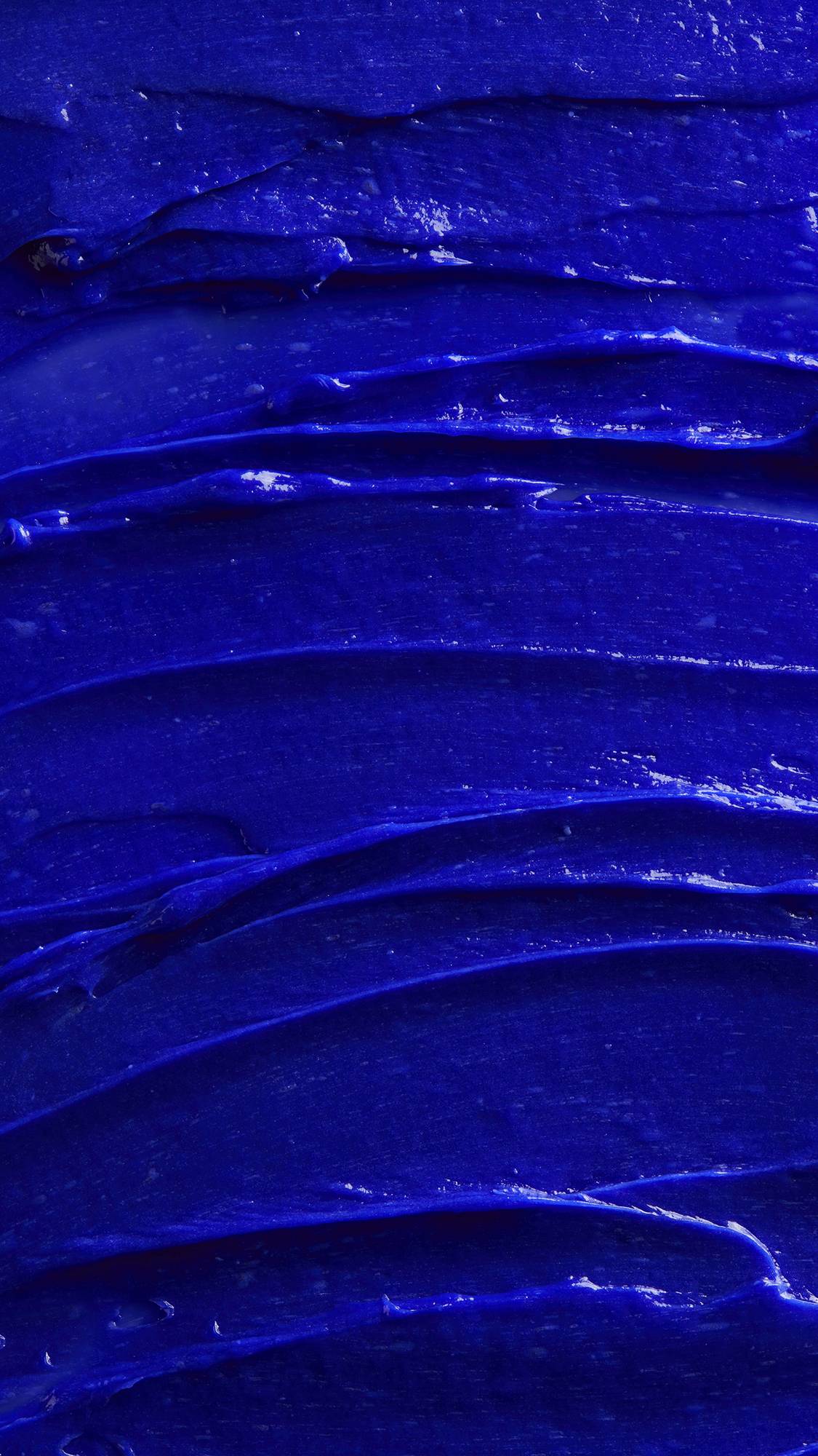 Image is a very defined close-up of the vivid violet shampoo spread covering the screen like a sea of thick blue batter.