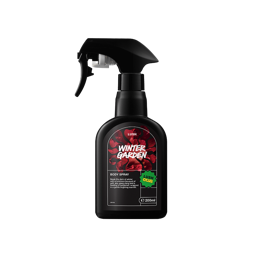 A black spray bottle of Lush "Winter Garden" body spray with a trigger nozzle and a black label featuring a deep red floral graphic and a green "Lush Club" sticker.