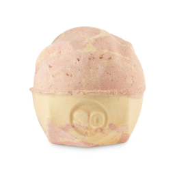 Yog Nog. A round, bumpy bath bomb with a flat, geometric base. The product is a marbled pale yellow and caramel colour with the number "30" embossed on the side. 