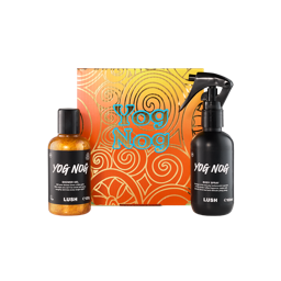 Yog Nog. A square cardboard box with an ombre yellow to orange design with golden swirls and text. A Yog Nog shower gel and Yog Nog body spray sit beside the box. 