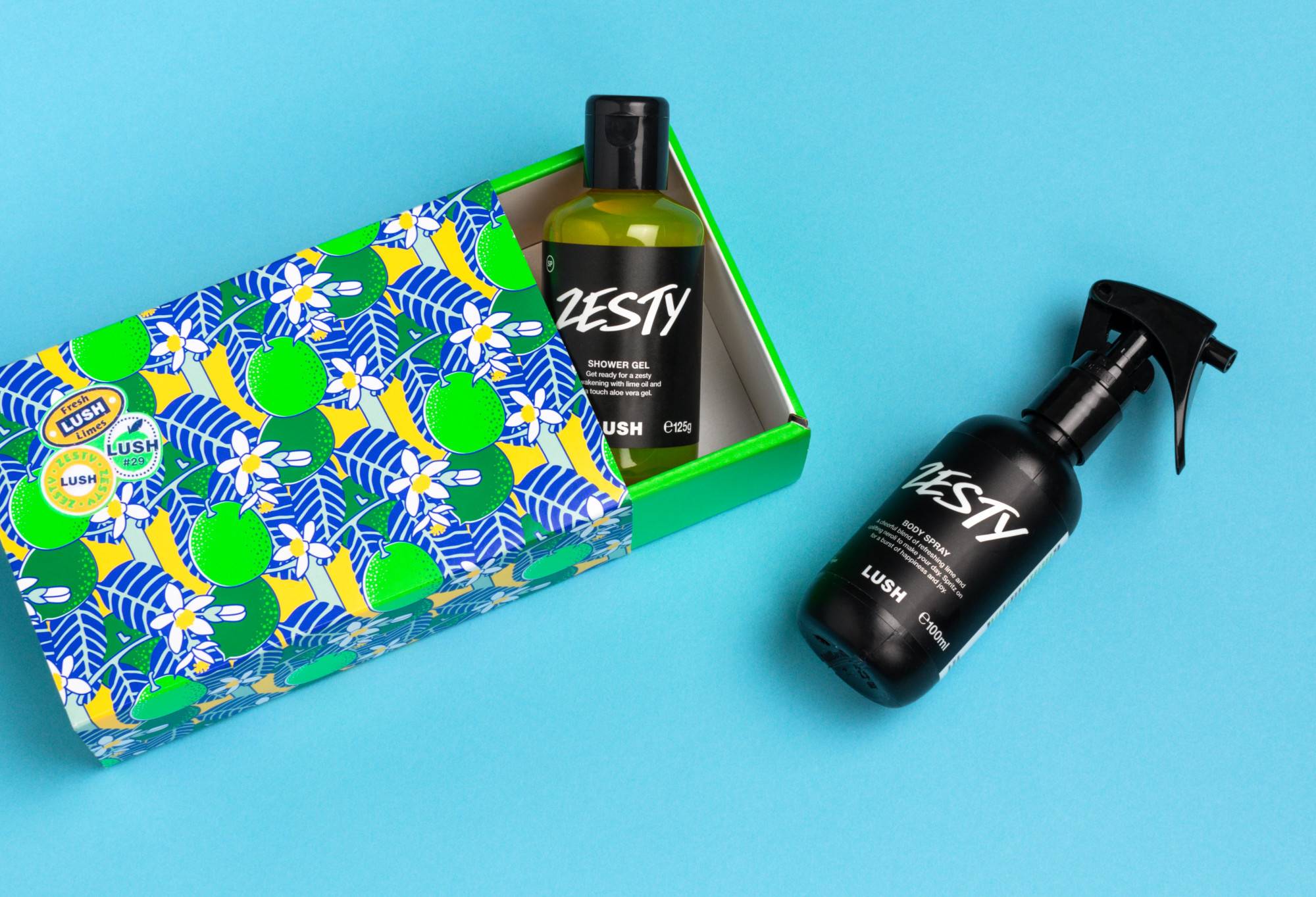 Zesty (the gift) box and its contents (100ml Body Spray and 100g Shower Gel) are displayed on a light blue background.