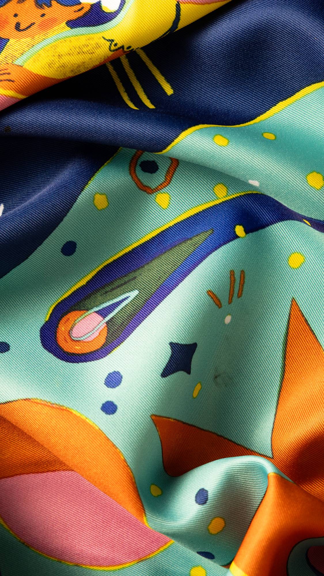 Image shows a super close-up of the Zodiac knot wrap. Focus on a vibrant comet flying through a blue, starry sky. 